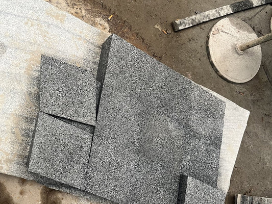 Grey granite tiles cut to size and stacked at the factory for an outdoor project