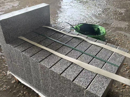 G623 granite kerbstones stacked on a pallet at the factory