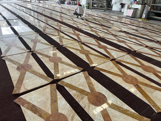 Factory dry-lay overview: Golden Spider + Valencia Cream waterjet floor modules laid out for inspection