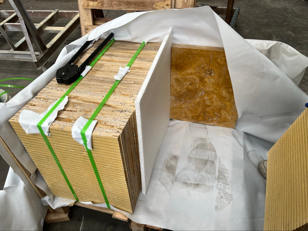 Finished golden travertine tile stacks in the packing area